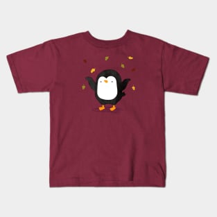 Penguin having fun with autumn leaves 2 Kids T-Shirt